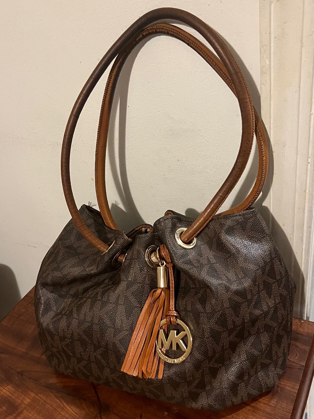 Michael Kors Mocha shoulder pouch bag with bag charm.